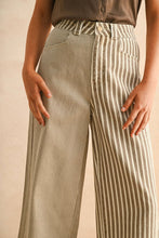 Load image into Gallery viewer, Brown and Cream Mixed Striped pants worn by a person on a beige background
