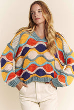 Load image into Gallery viewer, Woman wearing a colorful patterned sweater against a neutral background
