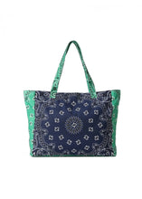 Load image into Gallery viewer, Oversized navy and green cotton canvas tote featuring a patchwork bandana paisley print, green side panels and matching shoulder straps on a white background.
