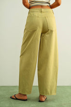 Load image into Gallery viewer, Olive green high-rise wide-leg jeans with relaxed barrel silhouette styled with sandals for an effortless everyday look.
