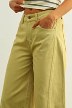 Load image into Gallery viewer, Olive green high-rise wide-leg jeans with relaxed barrel silhouette styled with sandals for an effortless everyday look.
