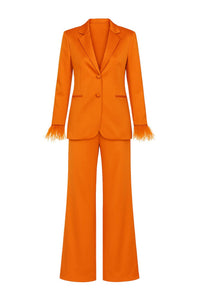 Orange suit with feather wrist cuffs on a white background