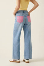 Load image into Gallery viewer, Back view of light-wash wide-leg jeans with oversized pink crystal embellished back pockets styled with a fitted knit top.
