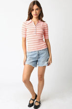 Load image into Gallery viewer, Woman wearing a pink striped polo shirt and denim shorts on a white background
