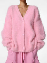 Load image into Gallery viewer, Model wearing a soft blush pink fuzzy cashmere blend cardigan sweater styled with matching pink cargo pants.
