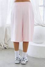 Load image into Gallery viewer, Light pink fleece Bermuda shorts with front pintuck detailing, elastic drawstring waistband, side pockets, relaxed fit, and soft stretch fabric.

