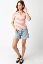Load image into Gallery viewer, Woman wearing a striped pink shirt and denim shorts on a white background
