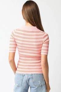 Woman wearing a pink and white striped shirt with blue jeans on a white background