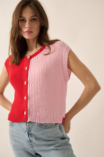 Woman wearing a red and pink ribbed knit cardigan on a plain background