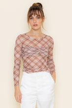 Load image into Gallery viewer, Woman wearing a plaid long-sleeve top with sheer overlay against a beige background
