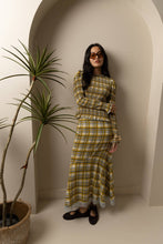 Load image into Gallery viewer, Yellow plaid midi skirt with lace trim hem worn by model.
