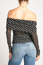 Load image into Gallery viewer, Person wearing a black polka dot off-shoulder top and blue jeans on a white background
