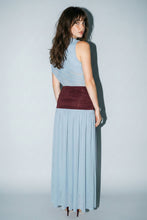 Load image into Gallery viewer, Model wearing a powder blue sleeveless mesh maxi dress with a mock neckline, burgundy ruched waistband, and flowing pleated skirt paired with burgundy heels.

