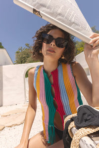 Woman wearing a colorful scarf and sunglasses outdoors