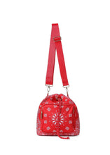 Load image into Gallery viewer, Red bandana print convertible bucket bag with drawstring closure and adjustable straps that can be worn as a backpack, shoulder bag, or crossbody bag.
