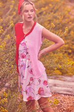 Load image into Gallery viewer, Woman wearing a floral dress and pink &amp; red cardigan in a natural setting with yellow flowers.
