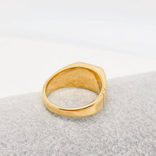 Load image into Gallery viewer, Chunky 18K gold-plated signet ring engraved with “rich bitch” and featuring ribbed detailing along the sides.

