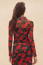 Load image into Gallery viewer, Woman wearing a Glam Expressway black and red floral skirt set with long sleeves on a beige background
