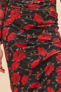 Close-up of a Glam Expressway black skirt with red floral pattern on black fabric
