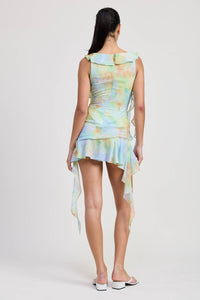 Woman wearing a tie-dye dress with a white background