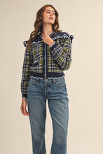 Load image into Gallery viewer, Model wearing a ruffled plaid knit cardigan with puff sleeves, scalloped trim, button-front V neckline, and contrast cable-knit yoke, styled with denim jeans.
