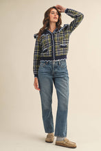 Load image into Gallery viewer, Model wearing a ruffled plaid knit cardigan with puff sleeves, scalloped trim, button-front V neckline, and contrast cable-knit yoke, styled with denim jeans.

