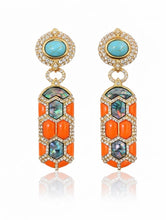 Load image into Gallery viewer, Ornate earrings with turquoise stones and orange accents on a white background
