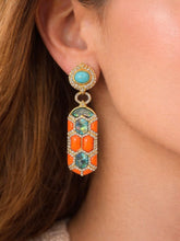 Load image into Gallery viewer, Close-up of an ear wearing a colorful earring with turquoise and orange stones.
