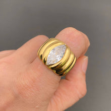 Load image into Gallery viewer, 18K gold-plated stainless steel statement ring with a large sparkling marquise-cut zircon center stone and sculpted ridged band.
