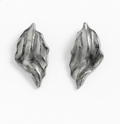 Textured sculpted silver wave earrings with organic curved shapes shown on a white background.
