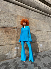 Load image into Gallery viewer, Person wearing a blue outfit standing on a stone pavement.
