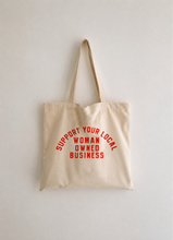 Load image into Gallery viewer, Natural cotton canvas tote bag with red "Support Your Local Woman-Owned Business" graphic displayed against a clean white background.
