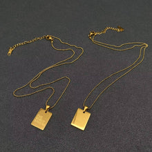 Load image into Gallery viewer, 18K gold-plated rectangular pendant necklace engraved with The World Is Yours on a delicate gold chain.
