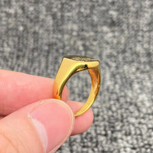 Load image into Gallery viewer, 18K gold-plated stainless steel signet ring engraved with “The World Is Yours” and finished with a high-polish surface.
