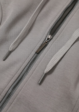 Load image into Gallery viewer, Dark gray fitted zip-up hoodie with orange sleeve stripes, oversized hood and dramatic layered ruffle bell sleeves.
