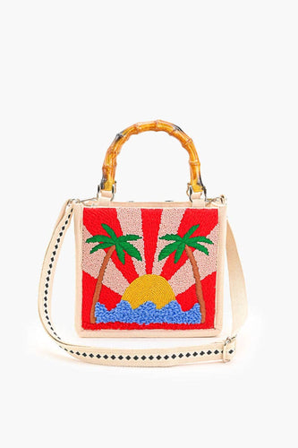 Handbag with a sun and palm tree design on a white background
