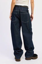 Load image into Gallery viewer, Person wearing dark blue jeans on a white background

