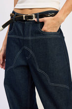 Load image into Gallery viewer, Person wearing dark blue jeans with a white background

