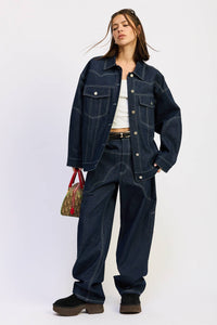 Woman wearing a denim outfit with a white background