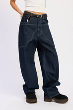 Load image into Gallery viewer, Person wearing dark blue jeans on a white background
