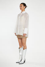 Load image into Gallery viewer, Introducing the White Organza Long Sleeve Button Down Shirt, an elegant and versatile staple for your wardrobe. Crafted from delicate organza, this chic piece effortlessly elevates any outfit. Wear it buttoned up for a polished look or layered over a bralette for a modern, trendy twist. Perfect for any occasion, from the office to an evening out, this shirt is your go-to for instant sophistication.
