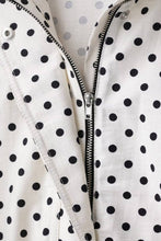 Load image into Gallery viewer, White cropped jacket with black polka dot print, featuring a high collar, long sleeves, and adjustable drawstring hem.
