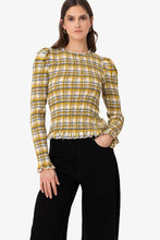 Load image into Gallery viewer, Yellow plaid smocked blouse with ruffle trim and long sleeves worn by model.
