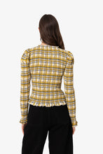 Load image into Gallery viewer, Yellow plaid smocked blouse with ruffle trim and long sleeves worn by model.
