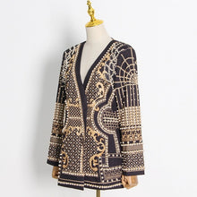 Load image into Gallery viewer, Elevate your wardrobe with our Gold Pearl Blazer, a striking black blazer adorned with luxurious pearls and a stunning gold design. This statement piece blends sophistication with bold glamour, making it perfect for turning heads at any occasion. Available in sizes S to 2XL, this versatile blazer is your go-to for a touch of elegance and drama. Wear it to command attention and make every moment unforgettable.
