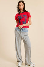 Load image into Gallery viewer, Unleash your sporty side with our Crop Jersey Tee Number 73! This baby tee blends comfort and style, featuring a soft jersey fabric that hugs your body just right. The bold number 73 adds a touch of athletic flair, making it perfect for casual outings or an active day out. Pair it with high-waisted jeans or your favorite shorts for a trendy, effortless look. Elevate your wardrobe with this must-have sporty staple!
