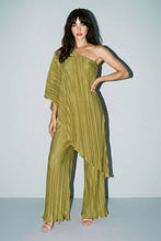 Load image into Gallery viewer, Model wearing an olive green pleated matching set featuring a one-shoulder asymmetrical flowy top and wide-leg pleated pants styled with nude heels for an elegant statement look.
