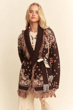 Load image into Gallery viewer, Chocolate brown tapestry-inspired jacquard knit cardigan with shawl collar, self-tie belt and multicolor fringe trim.
