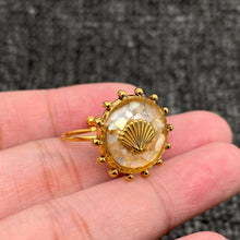 Load image into Gallery viewer, Adjustable 18K gold-plated stainless steel ring with a round shattered-shell mosaic face and raised gold scallop shell detail.
