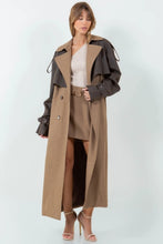 Load image into Gallery viewer, A long brown trench coat featuring a mix of vegan leather and traditional trench materials, offering a unique and chic style. 
